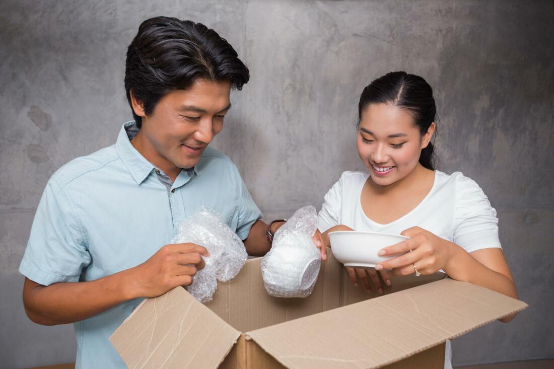 A man and a woman packing supplies together 