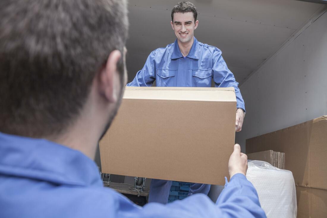 A gentle man giving a parcel another man